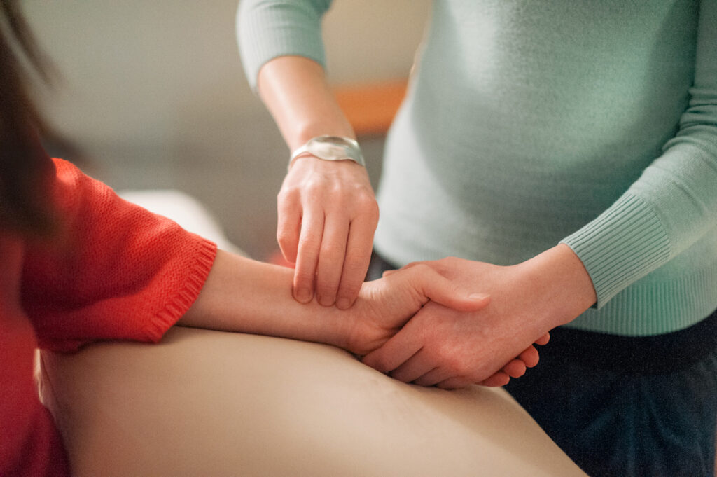 Acupuncturist taking pulses